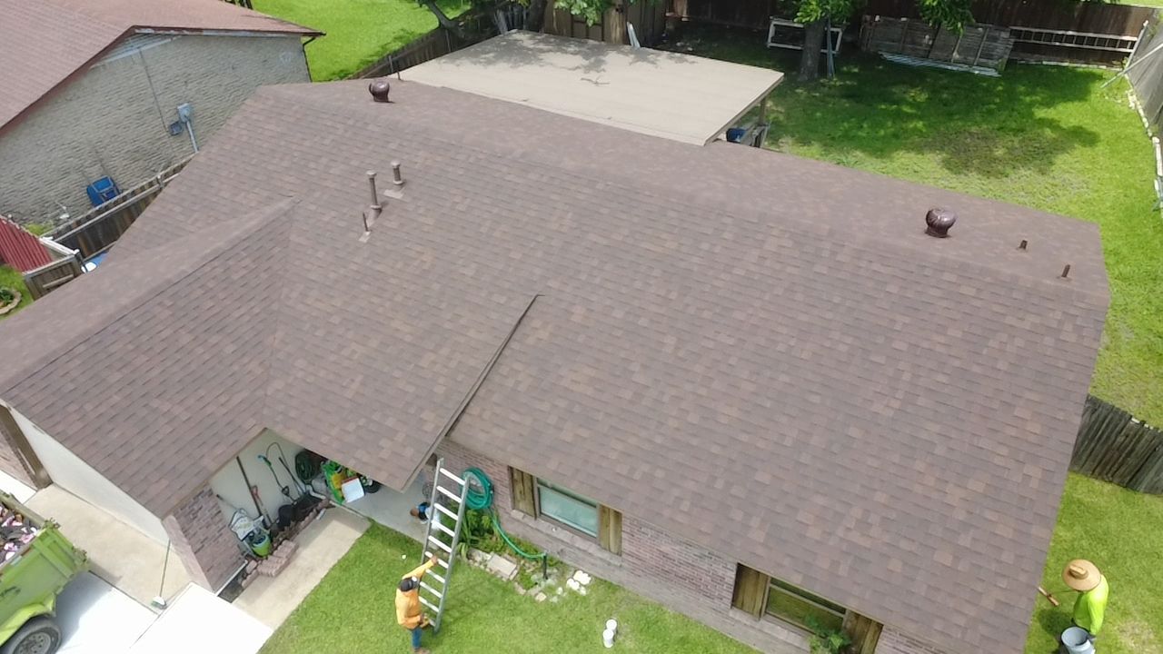 Aerial view of brown shingle roof installation